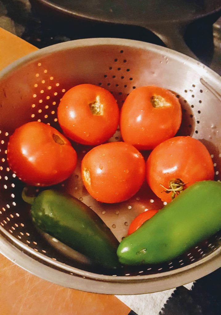 tomatoes and jalapenos in a colander 