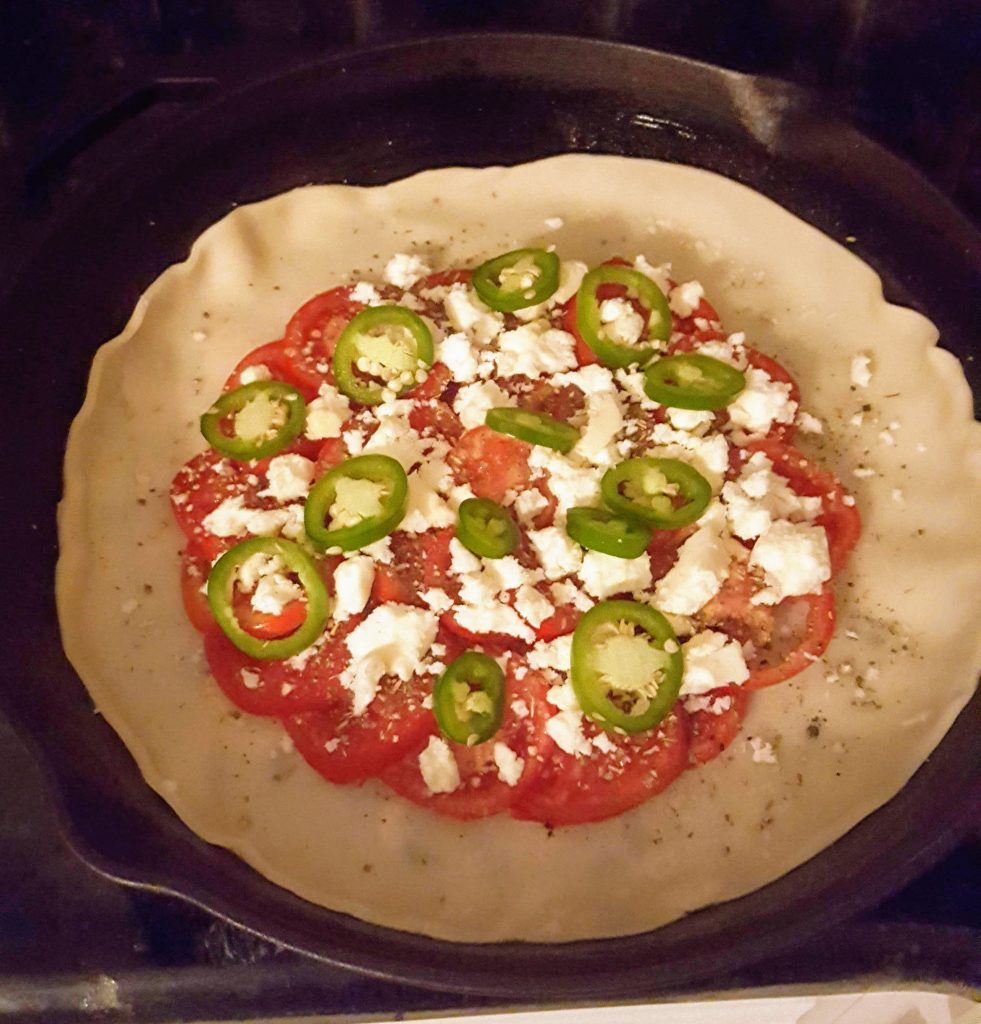 tomatoes, cheese, jalapenos slices  layered on pie shell 