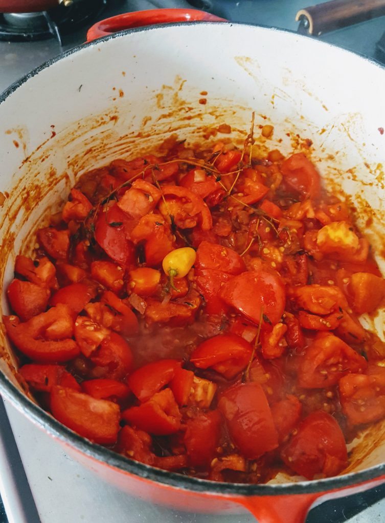 cooking chopped tomatoes in pot