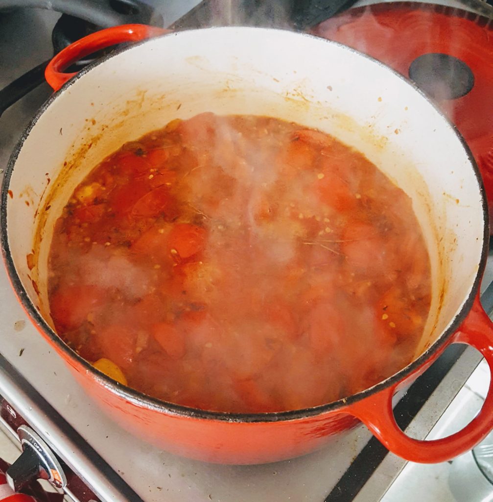 tomato soup ingredients stewing in enamel pot