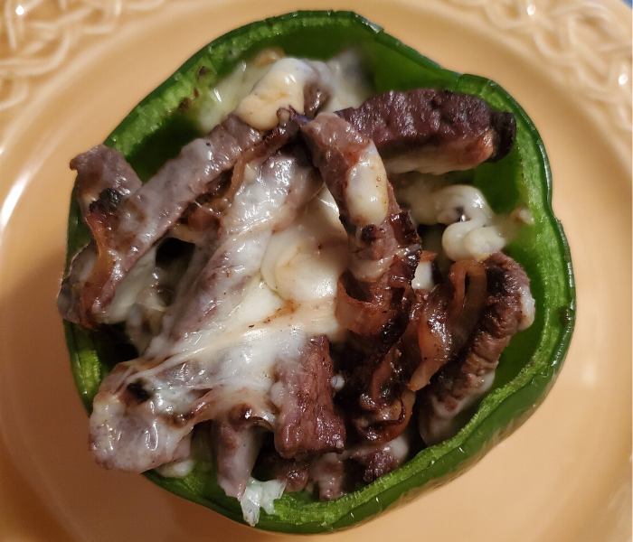 Keto cheesesteak stuffed pepper on a yellow plate