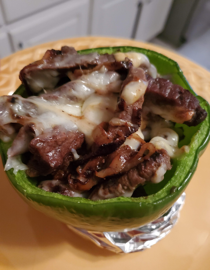 close up of Keto cheesesteak stuffed pepper on yellow plate