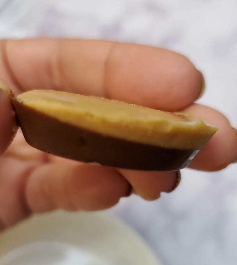 close up of hand held chocolate and peanut butter cup 
