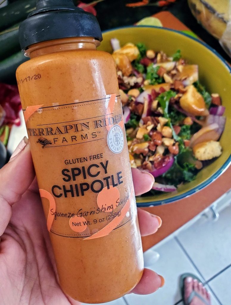 bottle of terrapin ridge farms garnishing sauce in front of a bowl of salad