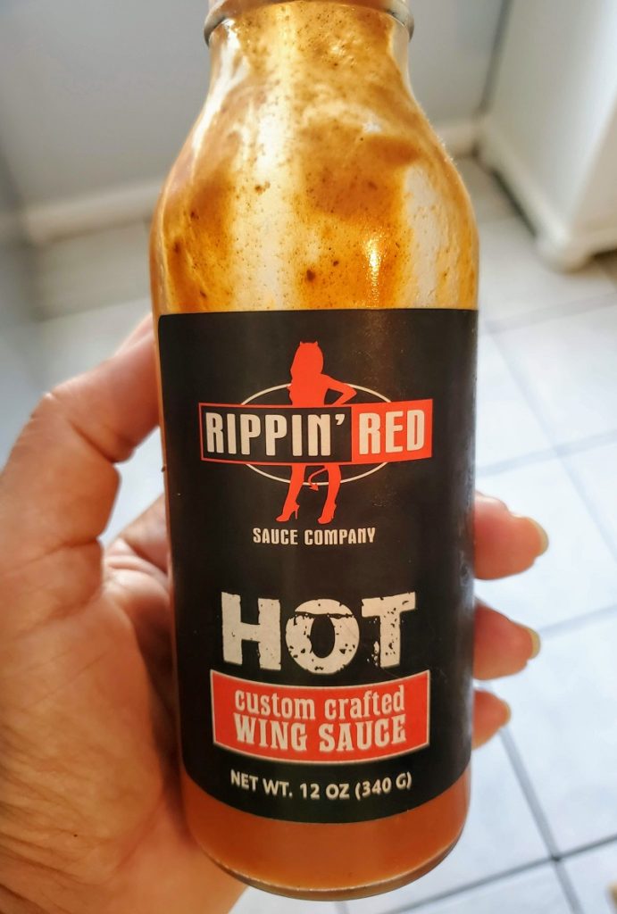 close up bottle of Rippin Red wing sauce