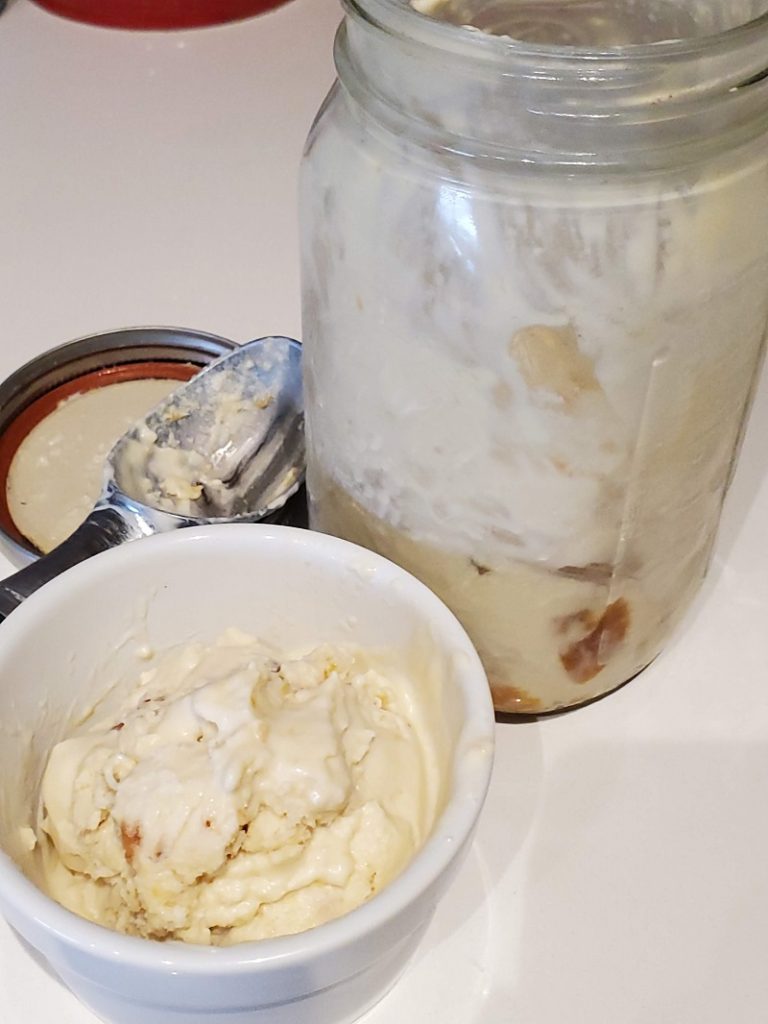 close up of hot peaches and cream in bowl and jar