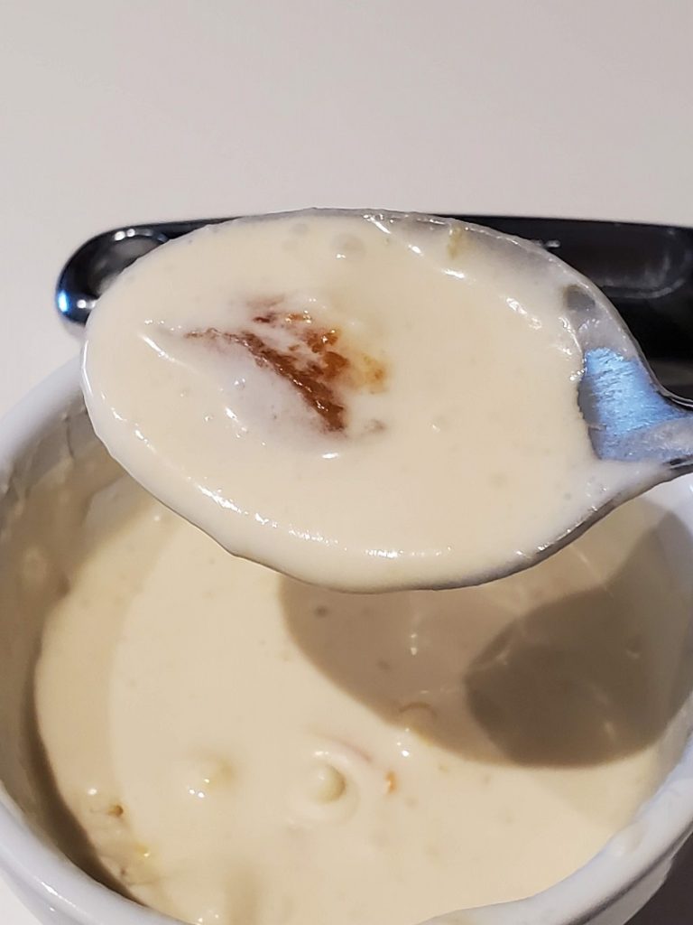 a close up spoon of melted ice cream